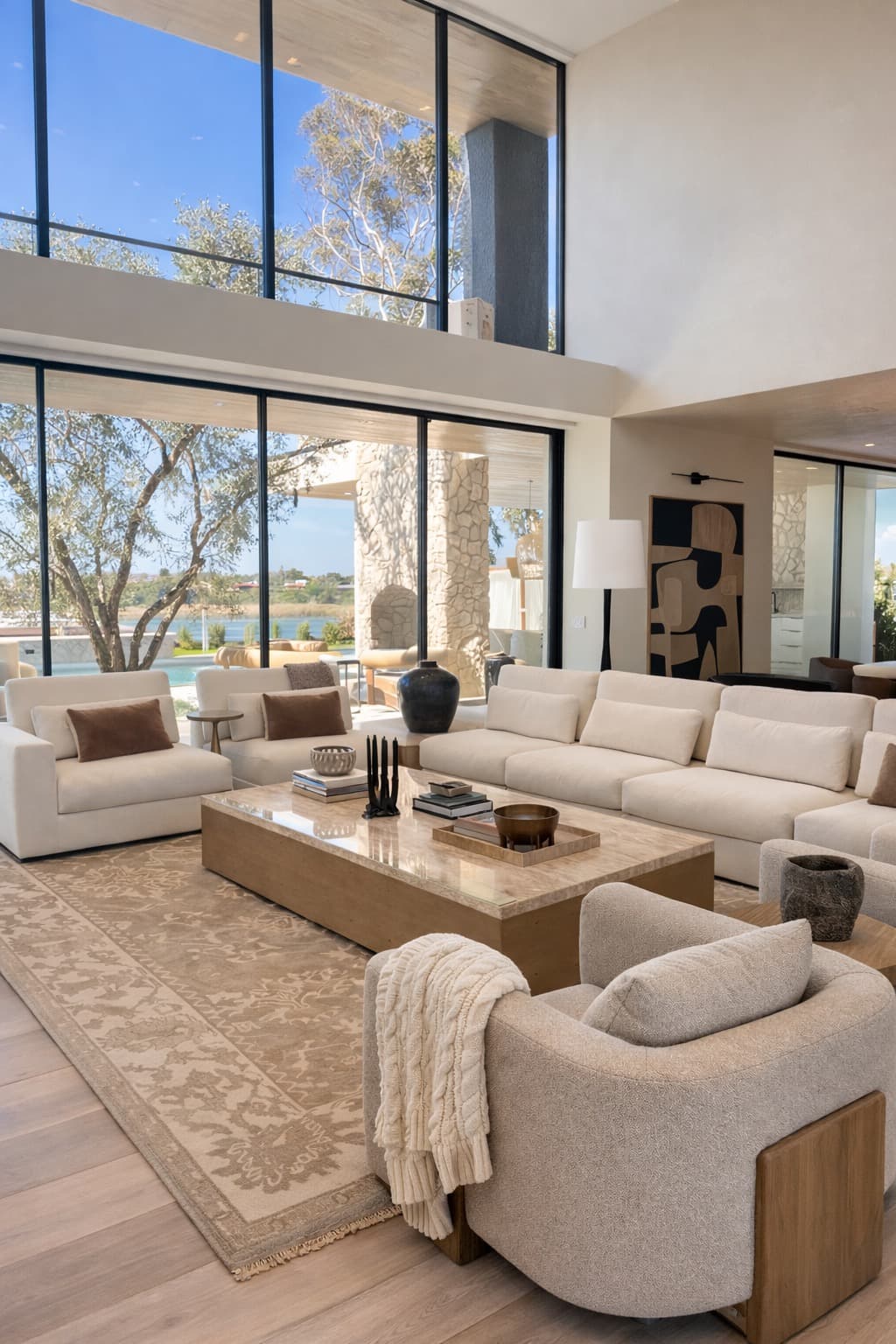 Modern luxury living room with neutral Oriental rug and ocean view by Aja Rugs
