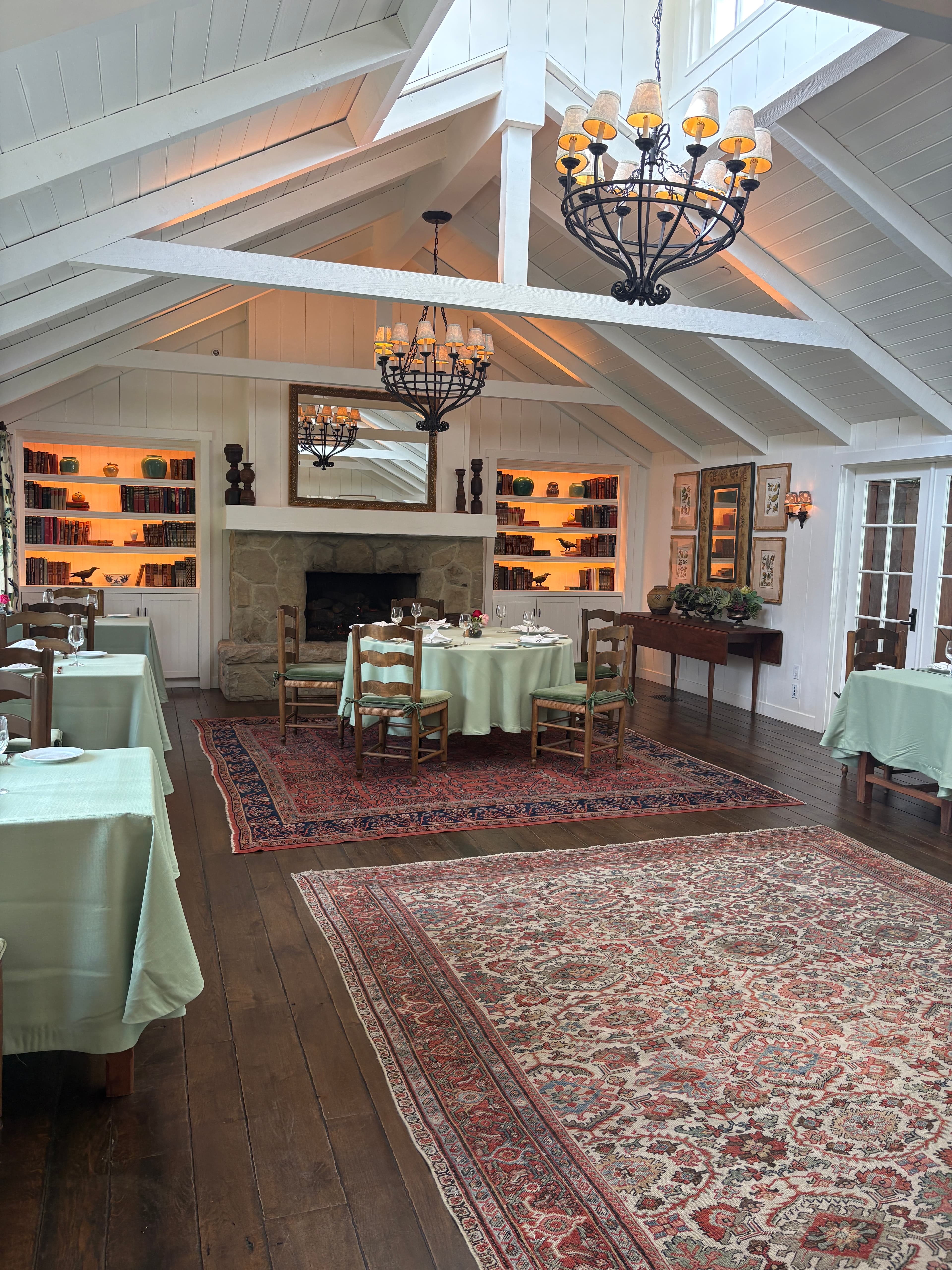 Elegant restaurant with Persian rugs and chandeliers - Aja Rugs installation