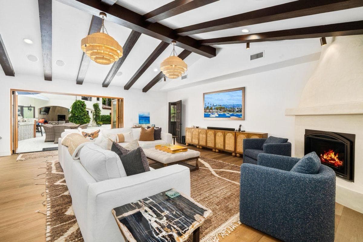 Coastal living room with exposed beams and artisan rugs by Aja Rugs