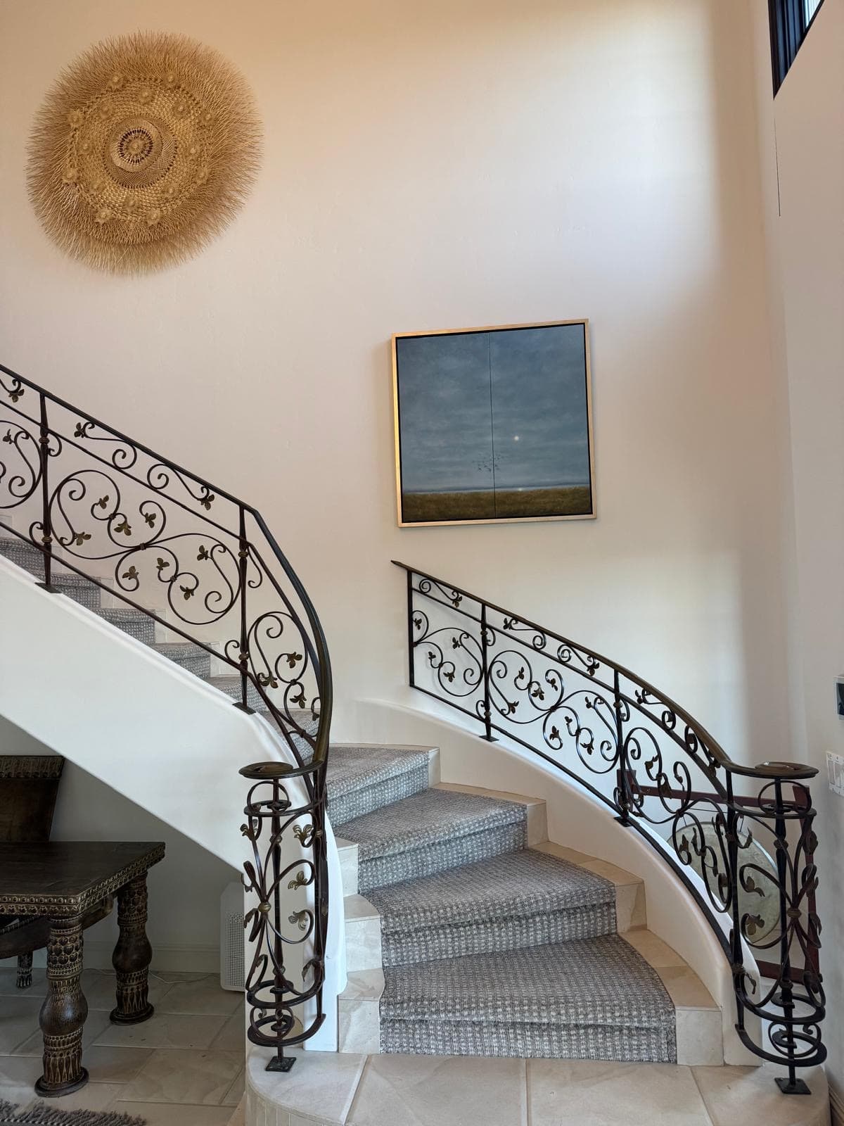 Elegant curved staircase with custom carpet runner by Aja Rugs